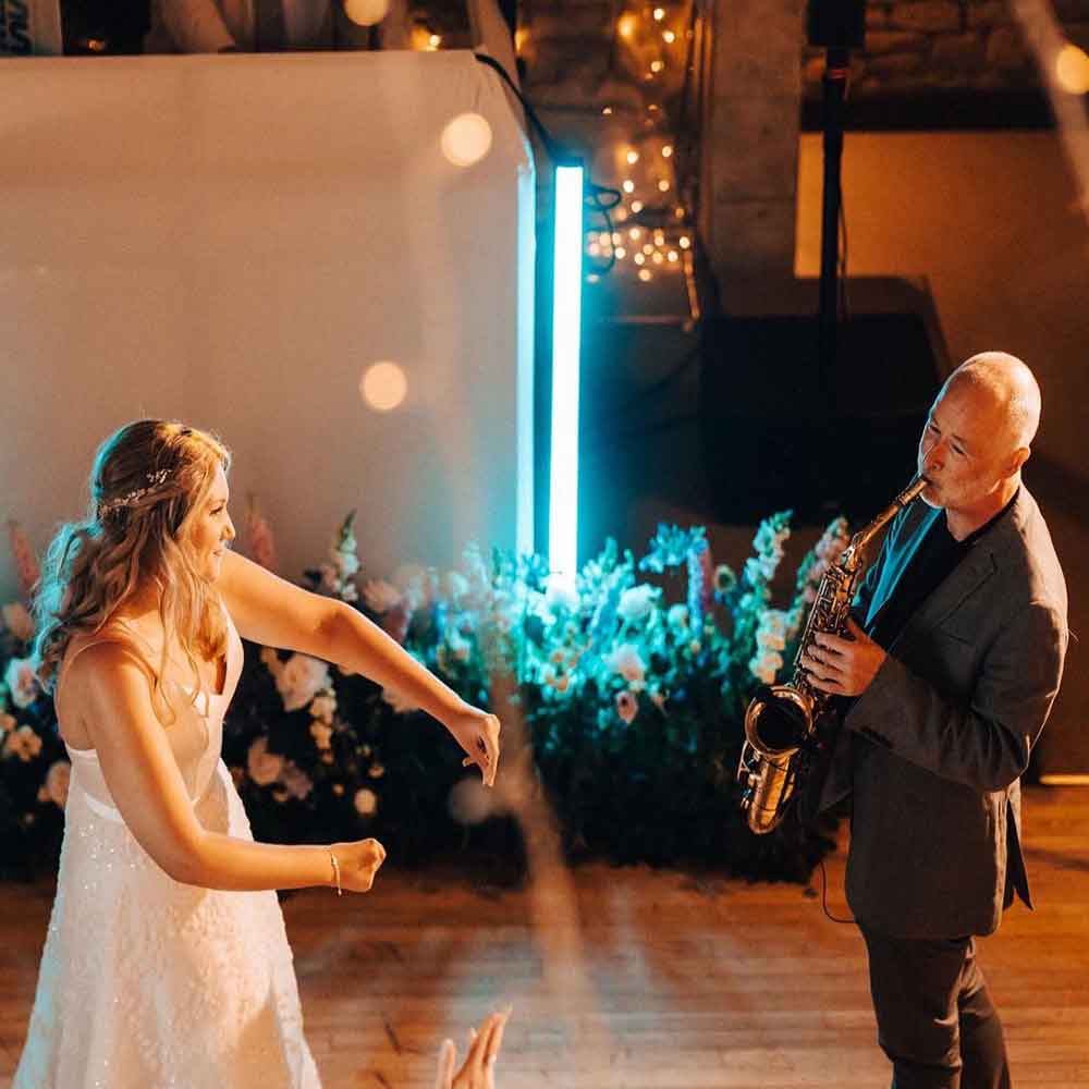 Bridesmaid dancing with saxophone player